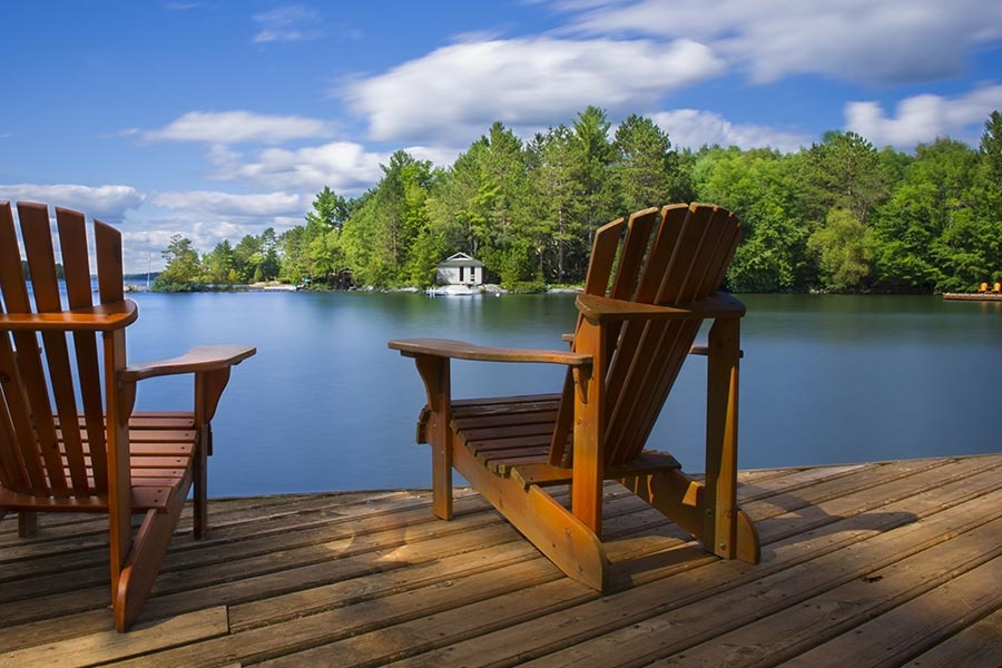Somerset, KY Insurance - Two Adirondack Chairs on a Wooden Dock Overlooking a Small Lake